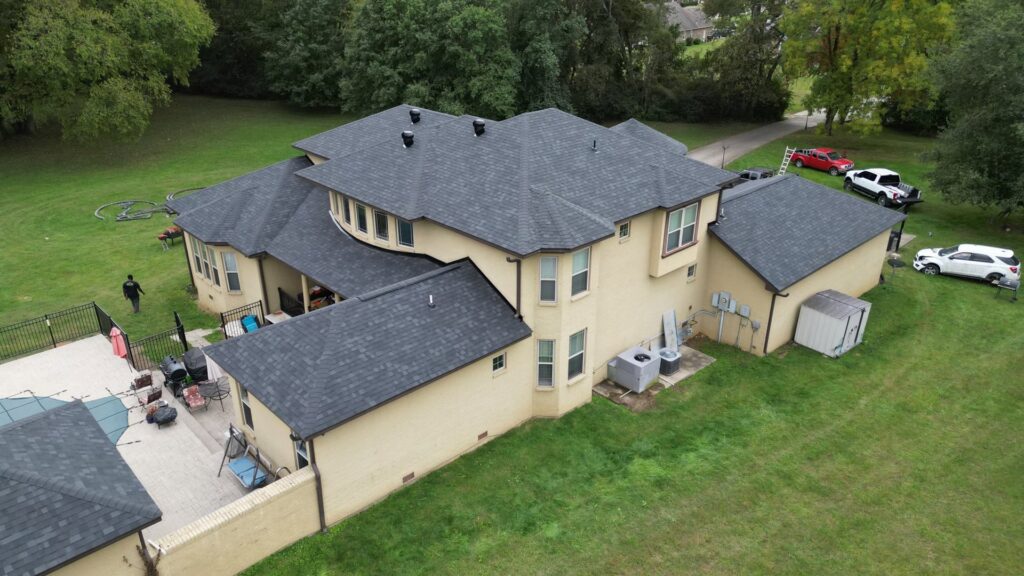 An aerial view of a large residential house with a newly completed roof by Southern Roofing and Renovations Clarksville in Orlando, FL.
