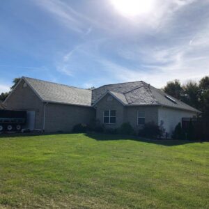 A residential house with a newly completed roof installation by Gwen Co in St. Louis, MO.