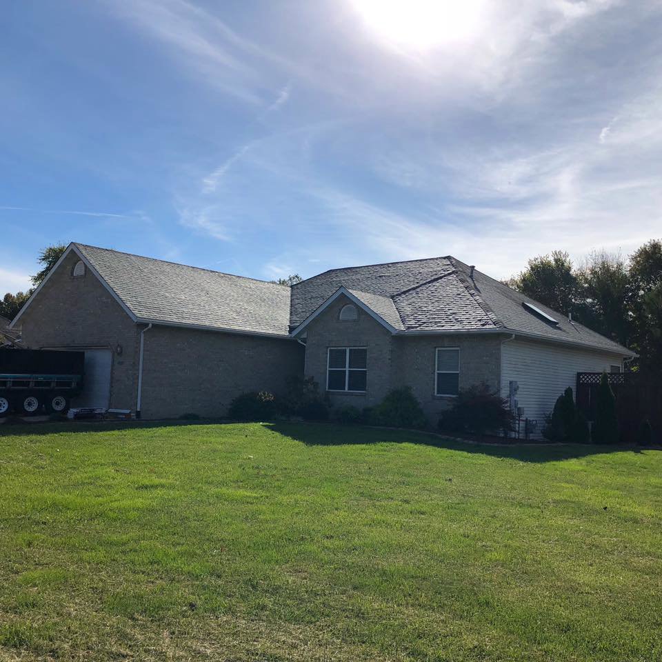 A residential house with a newly completed roof installation by Gwen Co in St. Louis, MO.