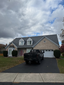A newly renovated roof on a residential home, with a Luxe Renovations truck parked in the driveway in Schaumburg, IL.