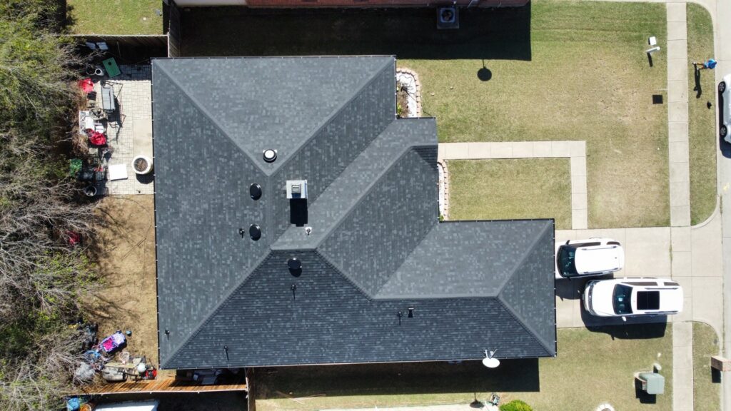 Top-down aerial view of a newly completed roof by Canek Construction LLC in Fort Worth, TX
