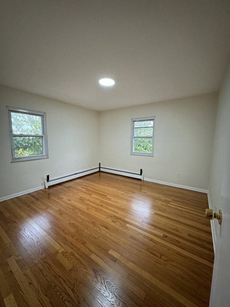 A completed room featuring beautiful new hardwood floors installed by Shore Flooring Solutions in Edison, NJ.