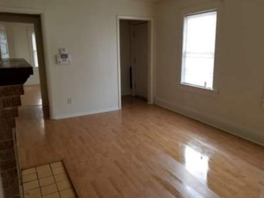 A completed interior room featuring light wood flooring and fresh paint, a renovation service by Huntington Home Repair in Huntington, WV.