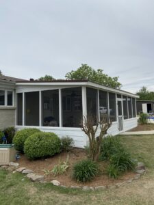 A beautifully completed screened-in porch or sunroom attached to a house, a project by Lee's Handyman Service LLC in Oxford, MS.
