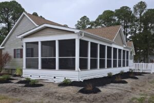 A completed screened porch addition on a house by M. Phippin Contracting in Hebron, MD.