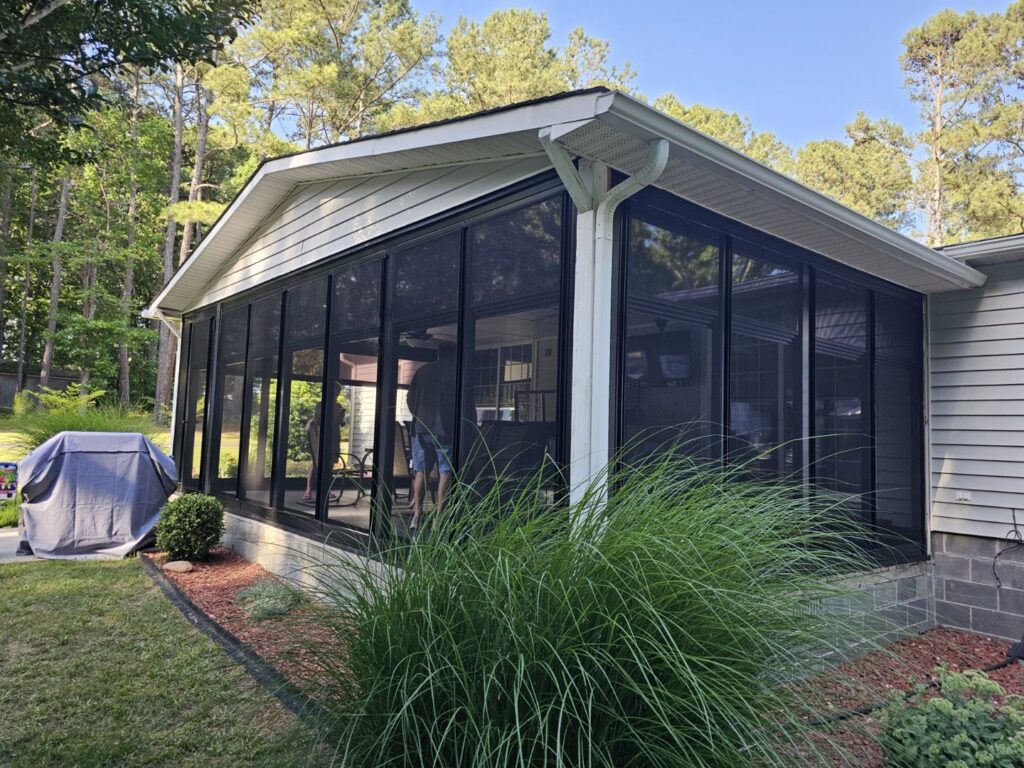 A beautifully completed screened porch addition on a house by X-Terior Techs in Henrico, VA.