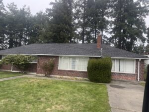 A newly completed shingle roof on a brick house by Sunny's roofing LLC in Denver, CO.