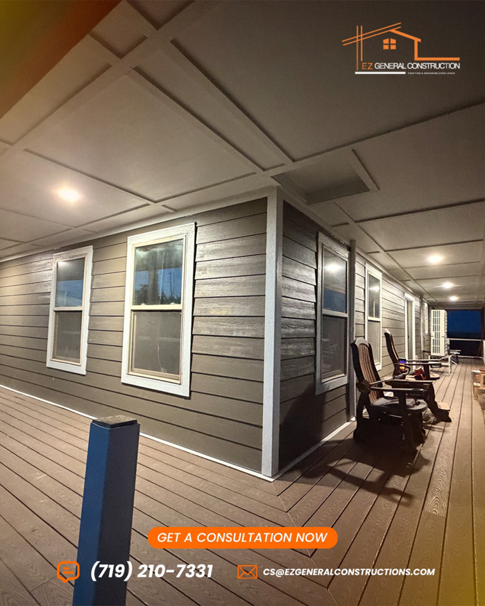 A completed exterior renovation project featuring new brown siding and a wooden deck by EZ General Construction LLC in Colorado Springs, CO