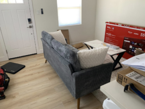 A newly assembled sofa with a handyman's tools nearby, showcasing completed furniture assembly by Honest Handyman Service in Phoenix, AZ.