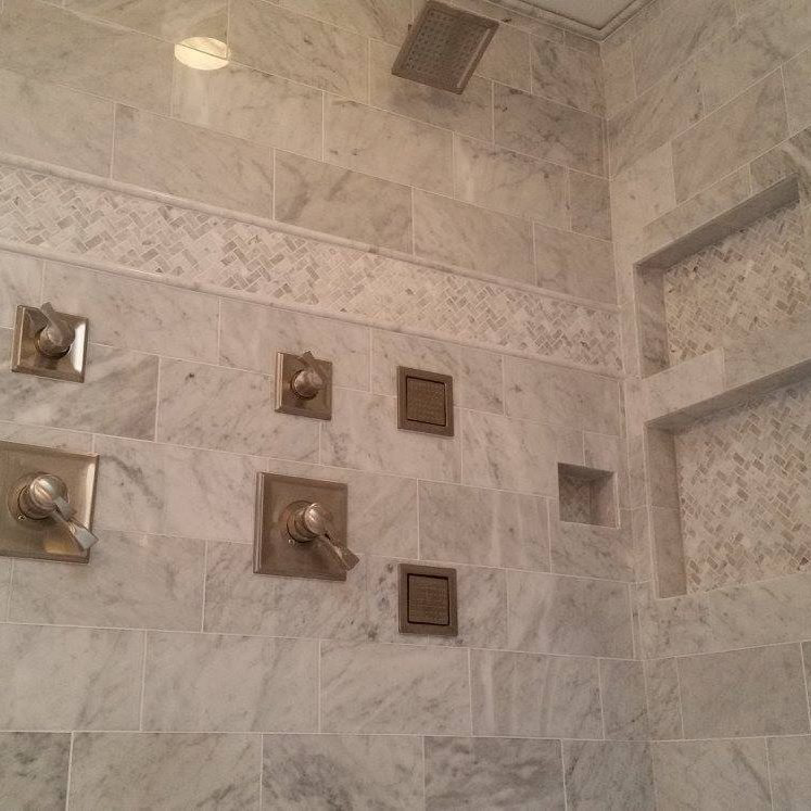 A beautifully completed tiled shower installation with modern fixtures and niches by Clayton Family Tile, LLC in Chandler, AZ