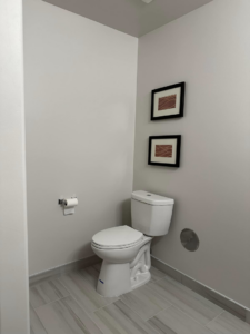 A completed toilet area with a modern toilet and tiled floor by Jay's Construction in Cincinnati, OH.