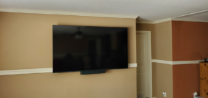 A completed TV wall mount installation with hidden wires and a soundbar by Walnut Bridge Construction in Knoxville, TN