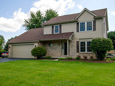 A completed two-story residential home with a brown roof and light siding, a project by Elk Building Services in Toledo, OH.