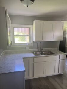 A newly completed kitchen remodel featuring white cabinets and light countertops by Jarrett's Home Improvements & Maintenance Services in Columbus, OH