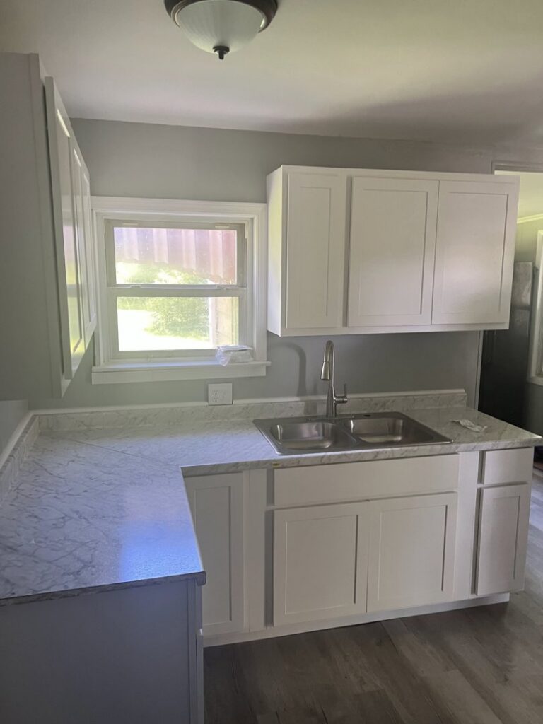 A newly completed kitchen remodel featuring white cabinets and light countertops by Jarrett's Home Improvements & Maintenance Services in Columbus, OH