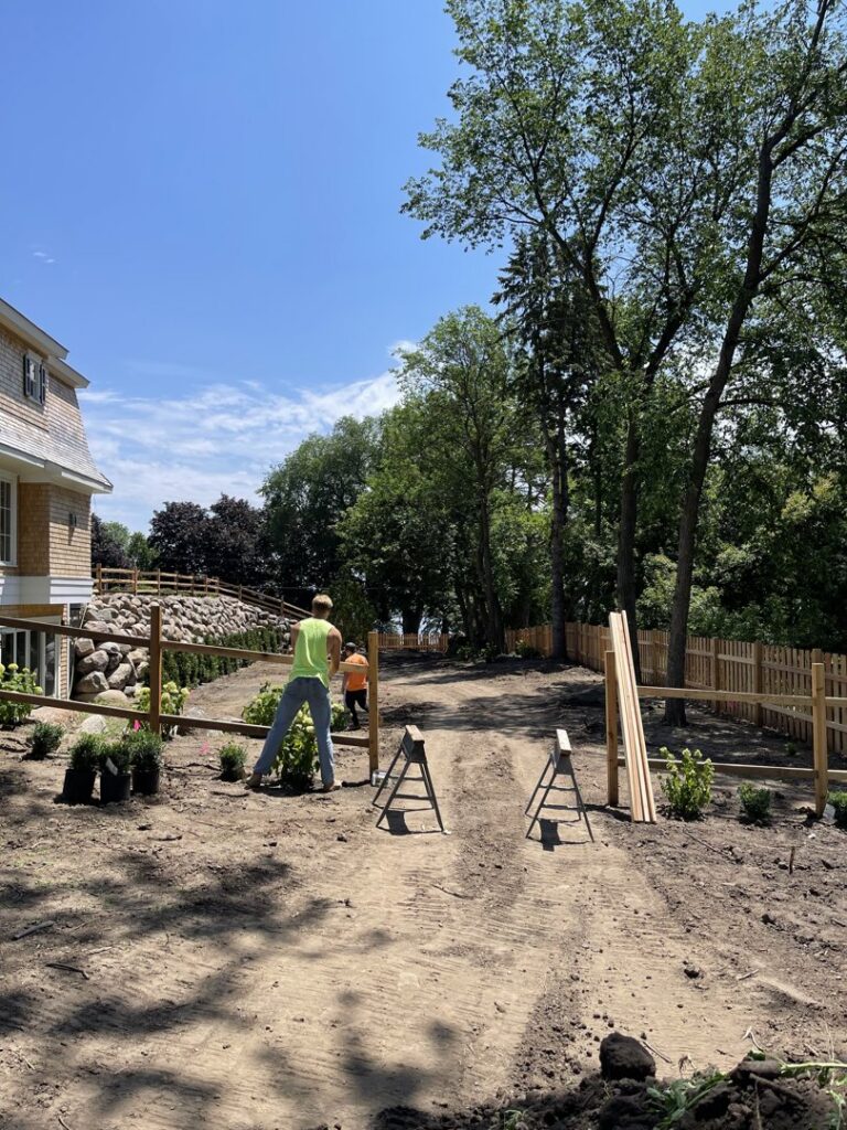 A completed wooden fence with a decorative gate, showcasing work by Security Fence & Construction Inc in Minneapolis, MN.