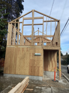 A completed wood-framed structure with partial sheathing, showcasing work by Mode Contracting in Seattle, WA.