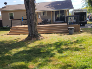 A wide view of a completed wooden deck addition on a house exterior by Zig's Home Improvements in Reading, PA.