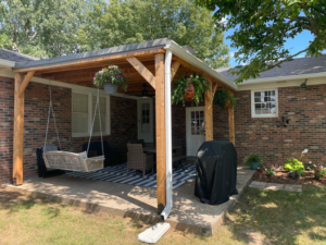 A beautifully completed wooden patio cover with a metal roof, built by HC Homes & Consulting in Bowling Green, KY.