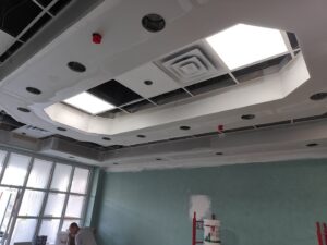 Detailed drywall ceiling installation with recessed lighting and vents, expertly completed by NED CO. in Springfield, MA.