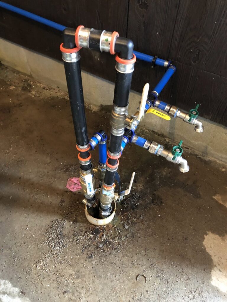 Complex outdoor plumbing manifold and spigot installation by Northern Air Plumbing & Heating in Aitkin, MN