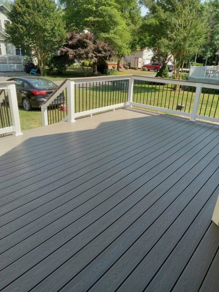 New composite deck installation with railings by A Man Who Can LLC, offering handyman services in Milford, DE.