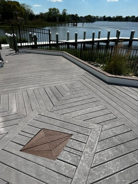 A newly installed composite deck with a decorative pattern by Priority Property Services in Salisbury, MD.