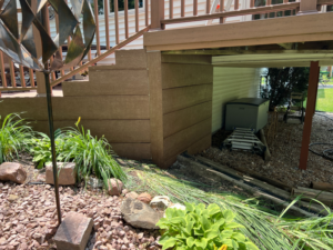 View of the underside of a composite deck, showcasing the finished skirting and support structure by Folmar's Handyman & Remodeling in Lincoln, NE.