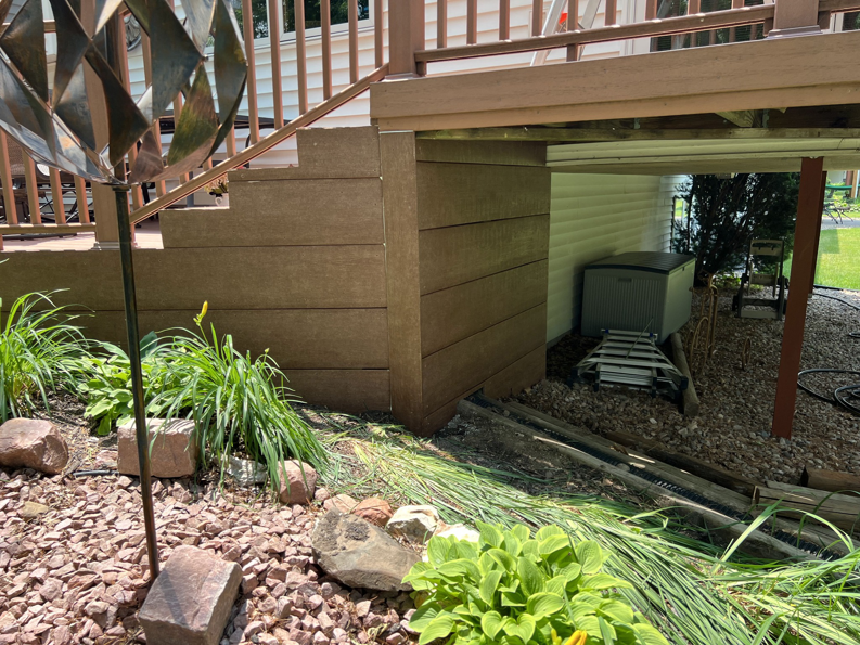 View of the underside of a composite deck, showcasing the finished skirting and support structure by Folmar's Handyman & Remodeling in Lincoln, NE.