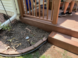 Close-up of composite deck steps and surrounding landscaping, showcasing quality outdoor work by Folmar's Handyman & Remodeling in Lincoln, NE.
