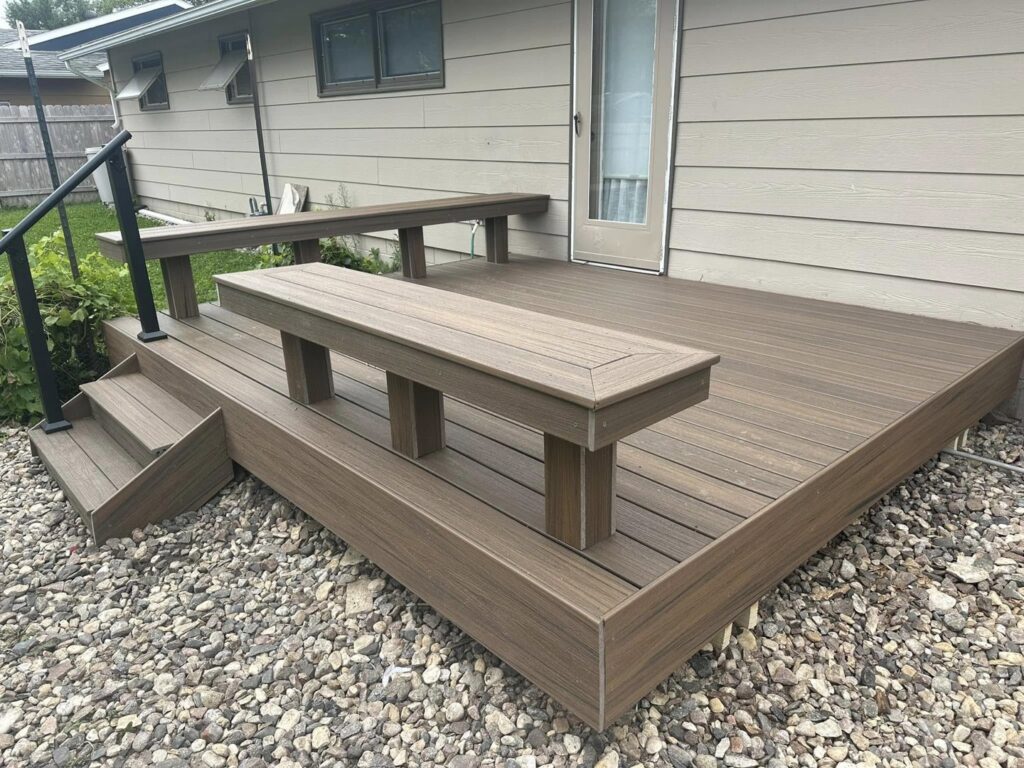 Custom-built composite deck featuring integrated benches and stairs, crafted by Watertown Handyman in Watertown, SD.