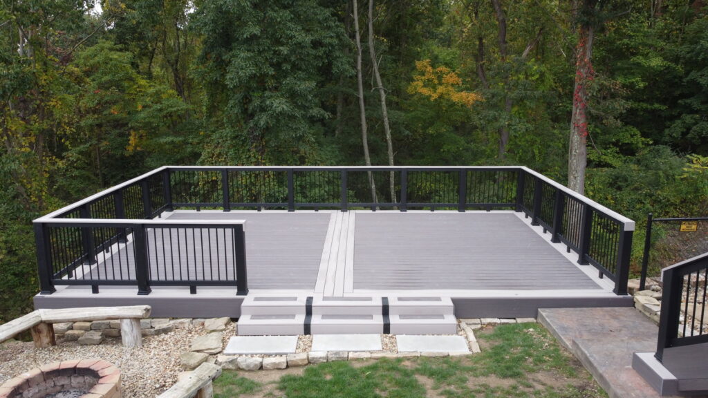 A newly installed composite deck with modern black railings and steps, built by McIntyre's Renovations LLC in Pittsburgh, PA