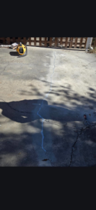 A concrete slab with a crack being repaired and sealed by Gulf Coast Foundation Solutions in Lafayette, LA