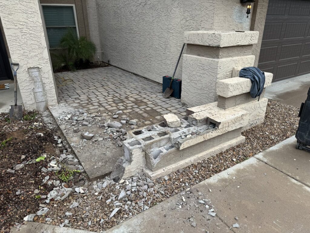 Demolished concrete block structure and rubble on the ground, showing debris removal by HAVOC Demolition in Scottsdale, AZ.