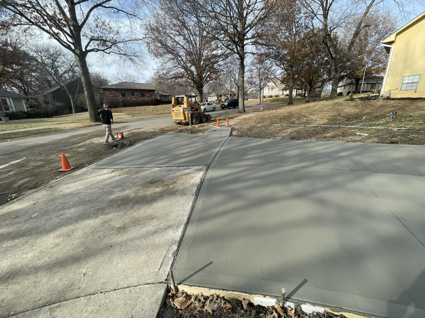 Construction of a new concrete driveway with a skid steer loader by DC's Precision Contracting LLC in Colorado Springs, CO.