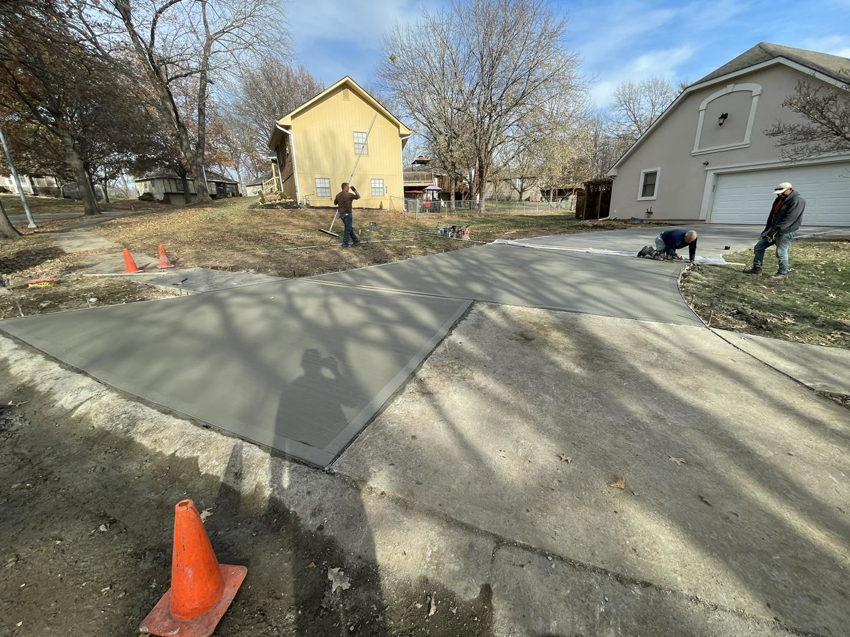 Workers installing a new concrete driveway for a home, a service provided by DC's Precision Contracting LLC in Colorado Springs, CO.