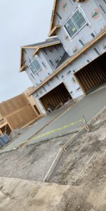 A concrete driveway leading to a new house under construction, a project by Moons Concrete & Construction LLC in Chicago, IL.