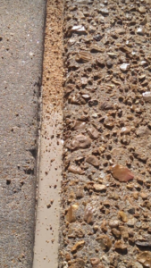 A close-up of a concrete expansion joint with fresh sealant applied by Concrete Crack Repair and Sealer - DrivewayDr.com in Saint Louis, MO.