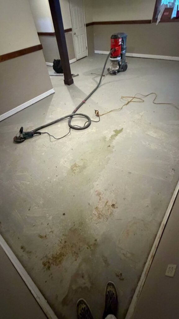 A concrete floor being prepared with a grinding machine for epoxy installation by Donnelly J. LLC Epoxy in St. Charles, MO.