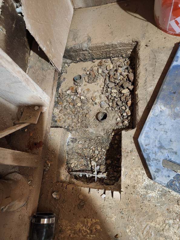 A concrete floor dug up for plumbing repair and installation by AJAC Restore&Construct LLC in Houma, LA.