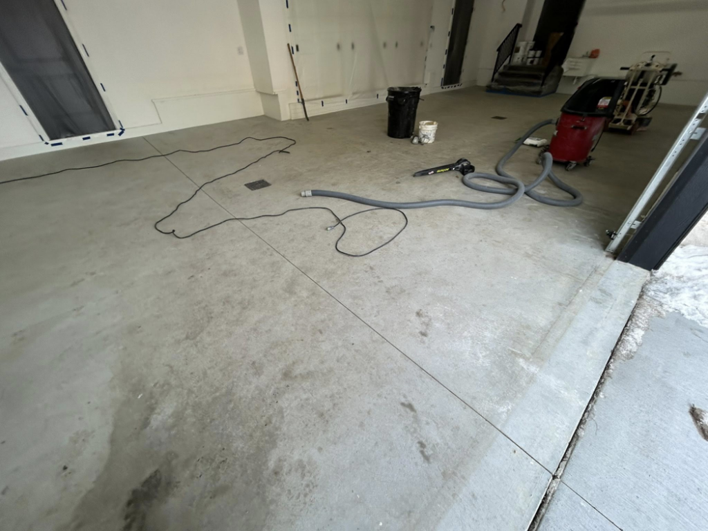 Concrete floor preparation with grinding and vacuum equipment by DuraFloor Epoxy Pros in Akron, OH.