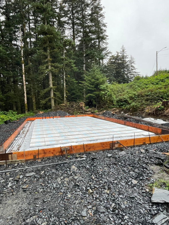 Concrete foundation formwork laid out on a gravel bed, ready for pouring by Form Fluent in Kodiak, AK.
