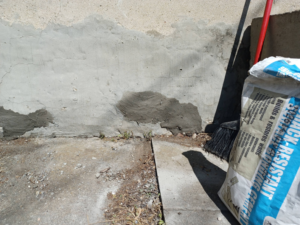 Close-up of concrete foundation patching with crack-resistant cement by Clifton Jones Handyman service in South Elgin, IL