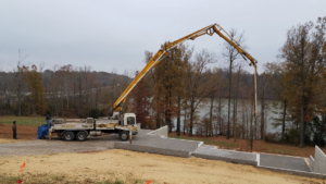 A concrete pump truck pouring a new foundation slab for a project by Fairview Concrete in Hopkinsville, KY.