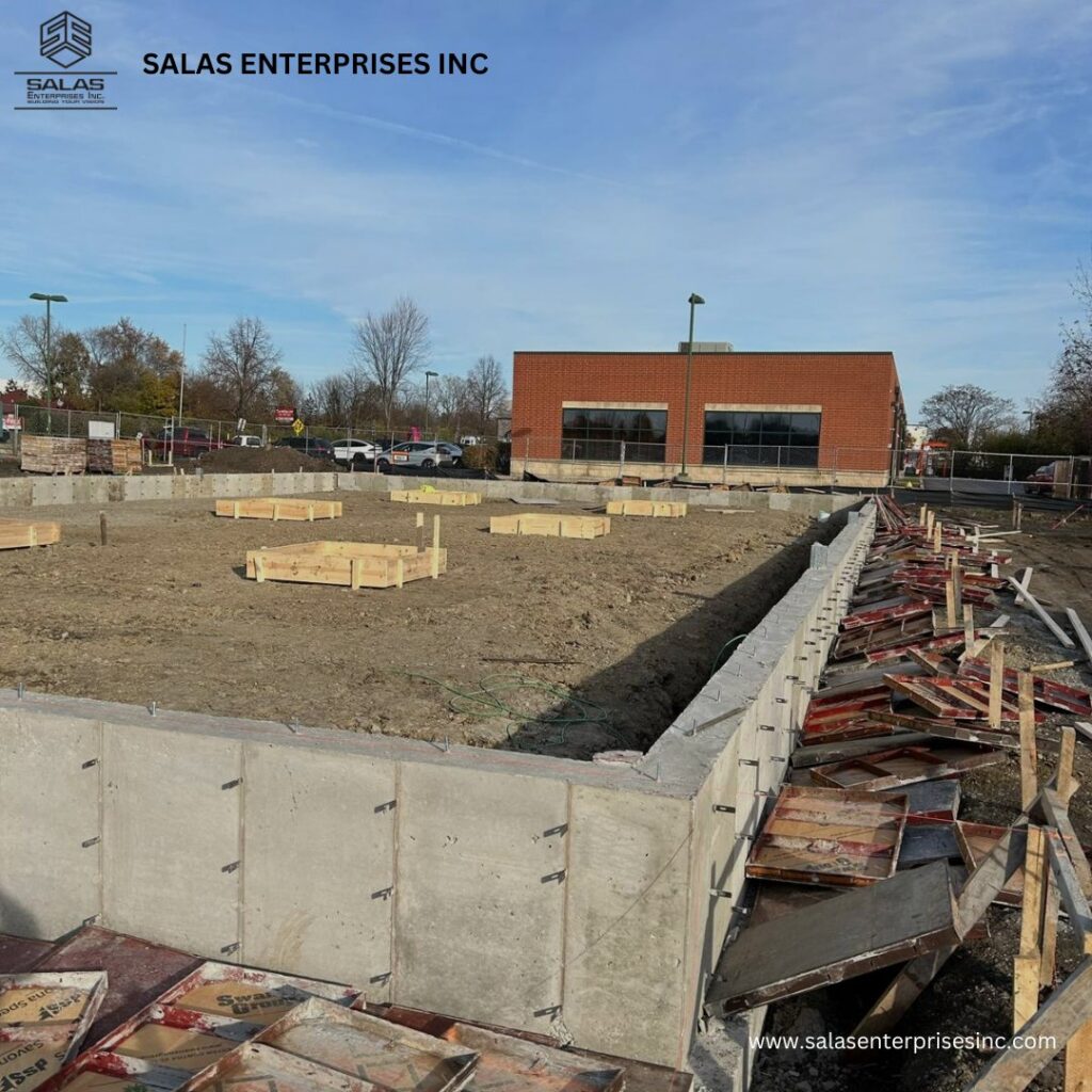 Concrete foundation walls and wooden forms at a construction site by Salas Enterprises, Inc in Elgin, IL.