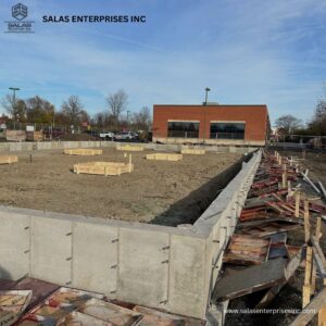 Concrete foundation walls and wooden forms at a construction site by Salas Enterprises, Inc in Elgin, IL.