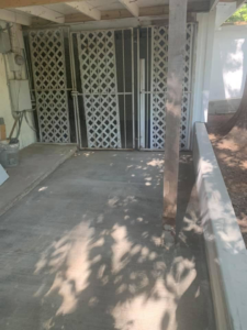 New concrete patio and decorative metal gate installation by Valdez Remodeling & Weatherization Inc. in Austin, TX