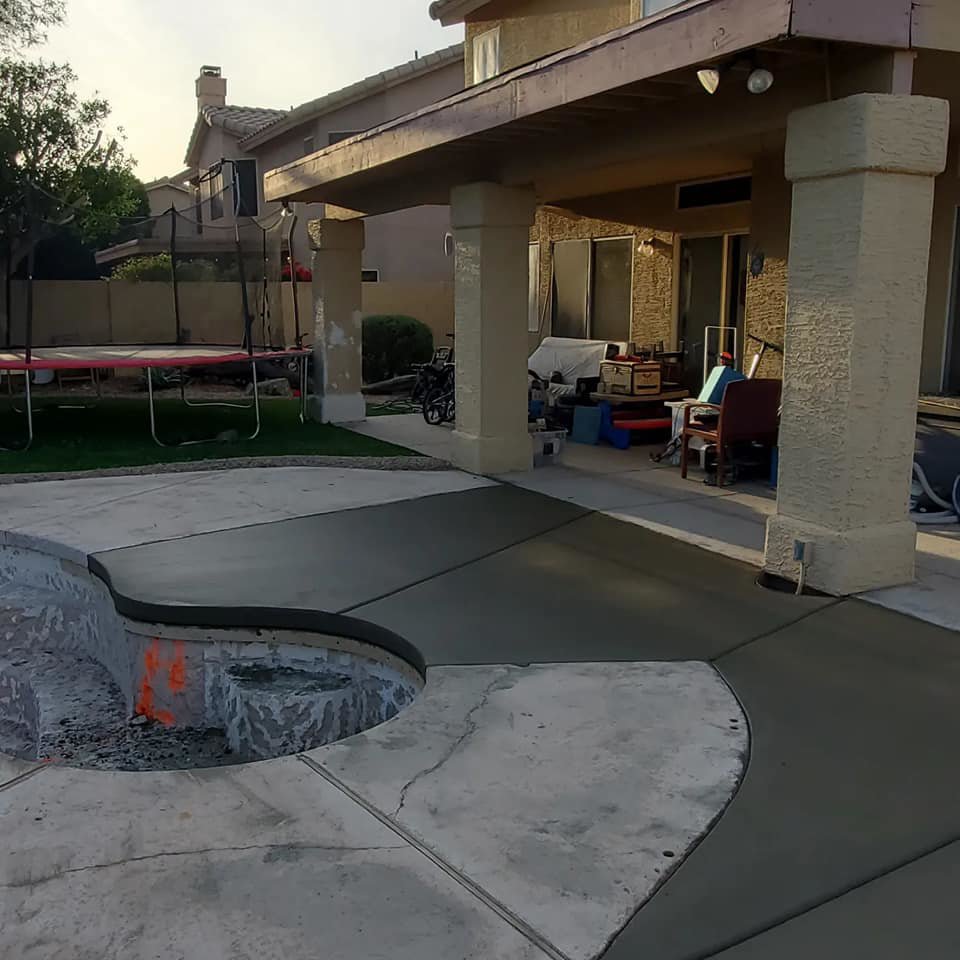 Concrete patio and pool deck installation next to a covered patio by Martin Jr's concrete in Surprise, AZ