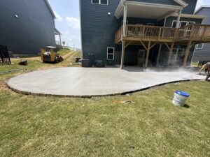 Concrete patio being poured and smoothed by Solid Rock Builders in Rock Hill, SC.
