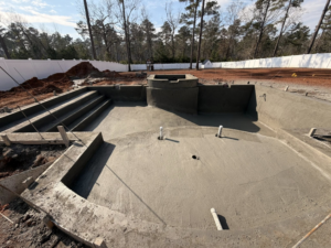 A concrete pool shell with integrated steps and spa area under construction by Ga Impact Shotcrete in Atlanta, GA.